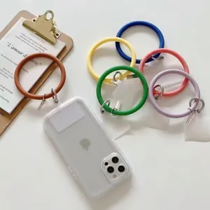 Colorful silicone phone wristlets with metal clasps displayed with a transparent case