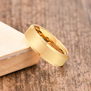 Close-up detail of polished gold tungsten steel ring with TUNGSTEN engraving inside