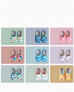 Detailed view of nine cartoon patterned non-slip baby indoor floor socks in various colors