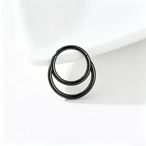 Detailed close-up of a black titanium steel double hoop piercing ring on a white background