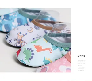 Detail view of non-slip baby indoor floor socks with cute dinosaur and astronaut prints