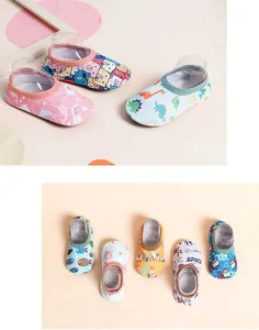 Detail view of non-slip baby floor socks featuring cute cartoon animal and space patterns