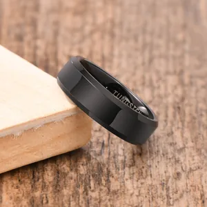 Macro view of a polished black tungsten steel ring for men with elegant beveled edges.