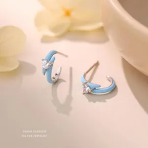 Detail view of s999 sterling silver bow-knot earrings with blue enamel and zircon