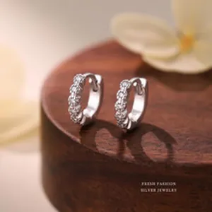 Close-up of S999 sterling silver hoop earrings with sparkling cubic zirconia stones.