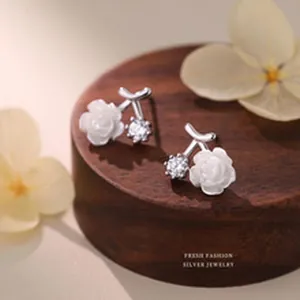 Macro view of elegant S999 silver flower earrings with sparkling zircon detail