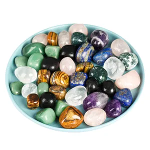 Assorted natural tumbled healing crystals and polished gemstones set on a plate