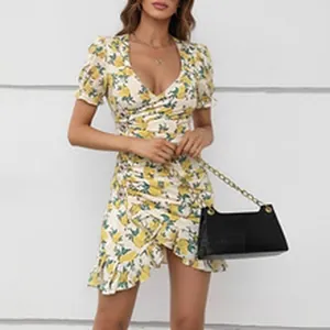 Detail of a floral V-neck spring dress with short sleeves and asymmetrical ruffled hem