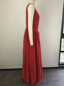 Elegant red sleeveless maxi dress with a cinched waist silhouette shown from the side.
