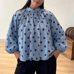 Detailed view of fashionable blue loose polka dot long sleeve blouse for women