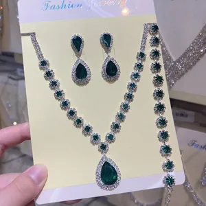 Close-up of elegant green teardrop rhinestone jewelry set with necklace and earrings