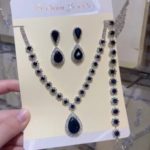 Close-up of elegant black crystal water-drop necklace, bracelet and earrings 3-piece set