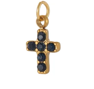 Close-up of gold stainless steel cross pendant with blue zircon stones, 0.9cm high