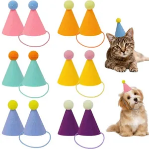 Set of colorful mini pet party hats with pom-poms for dogs and cats birthday celebration.
