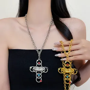 Detail of vintage punk cross necklace featuring surreal lip design and colorful gems