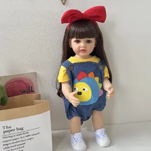 Realistic reborn baby doll in cute denim overalls and red bow headband toy