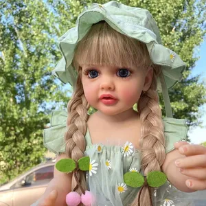 Detailed close-up of lifelike reborn baby doll wearing green floral dress and hat