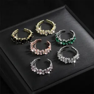Set of sparkling micro-set zirconia open rings in various colors on black jewelry box