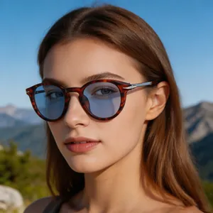 Close-up of retro round tortoiseshell sunglasses with blue lenses worn by a model outdoor