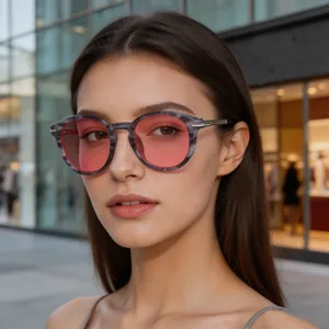 Close-up detail of retro round sunglasses with pink lenses and vintage grey frame