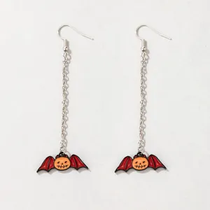 Detail of Halloween long earrings featuring pumpkin bat charms with enamel finish.