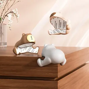 Close-up view of cute bear-shaped silicone corner protectors showing the adhesive backing strip