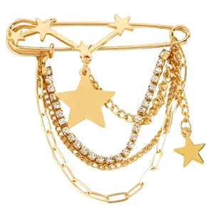 Detailed close-up of golden paperclip brooch with dangling stars and crystal chains