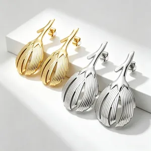Detailed macro shot of high-end retro gold and silver leaf-shaped stainless steel earrings