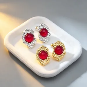 Detailed view of French vintage geometric earrings with red cat's eye stones