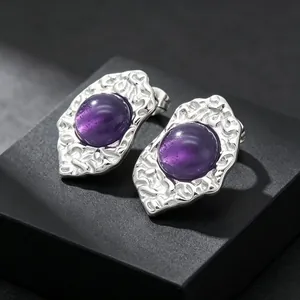 Detailed view of French retro titanium steel earrings with purple cat-eye stones
