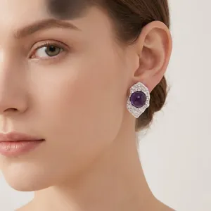 Close-up of a model wearing irregular silver-tone earrings with purple gemstones