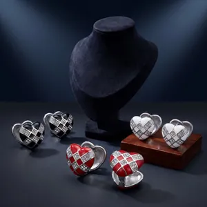 Detailed view of heart-shaped checkerboard earrings with sparkling crystal accents