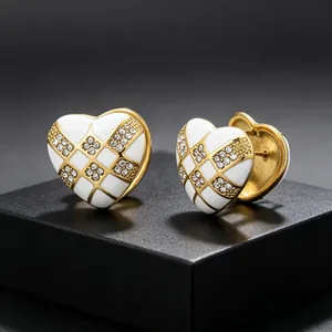 Detail view of high-quality white heart checkerboard earrings with sparkling stones.