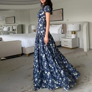 Side view of an elegant navy floral French maxi dress in a luxury bedroom setting.