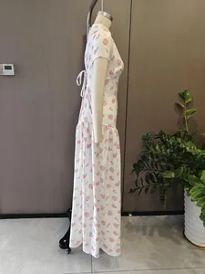 Detailed side view of an elegant white maxi dress with pink rose floral prints