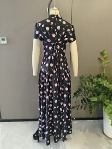 Detail view of French style floral maxi dress with back tie design and rose pattern.