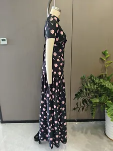 Side view of an elegant black French maxi dress with a pink rose floral print pattern