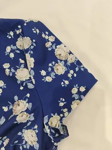 Detailed close-up of the elegant blue vintage floral print on a French style summer dress