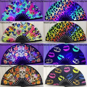 UV reactive bamboo folding fans showing glowing effects under fluorescent and natural light.