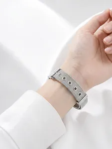 Close-up of stainless steel mesh bracelet worn on wrist in a minimalist style