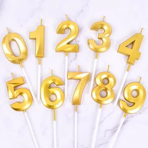 Full set of gold 3D faceted number birthday candles with sticks for cake topper.