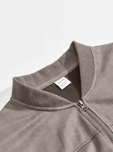 Detail view of men's brown suede jacket collar with XXL material tag and zipper