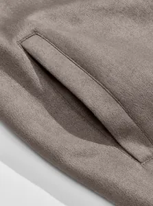 Close-up detail of pocket stitching and soft suede texture on men's jacket