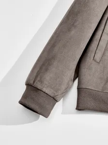 Detail macro view of soft suede fabric and ribbed cuff on a brown men jacket