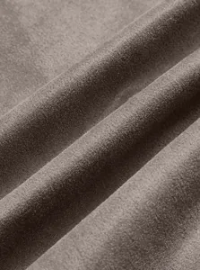 Detailed macro view of soft brown suede fabric texture on a casual sports stand collar jacket