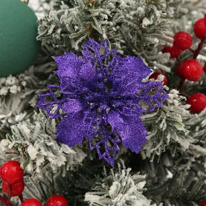 Detailed macro view of a purple glitter hollow-out poinsettia flower Christmas ornament