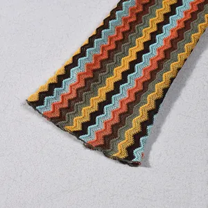 Detailed macro view of the multicolor chevron pattern and knit fabric on a long-sleeve dress.