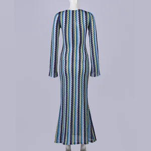 Back view of a slim long sleeve maxi dress featuring vibrant blue and yellow zigzag patterns.