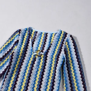 Close-up of elegant V-neckline on multi-colored zig-zag knit long-sleeve dress detail shot