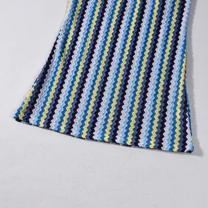 Close-up detail of the vibrant colorful zigzag hem on this stylish knit slim-fit dress.